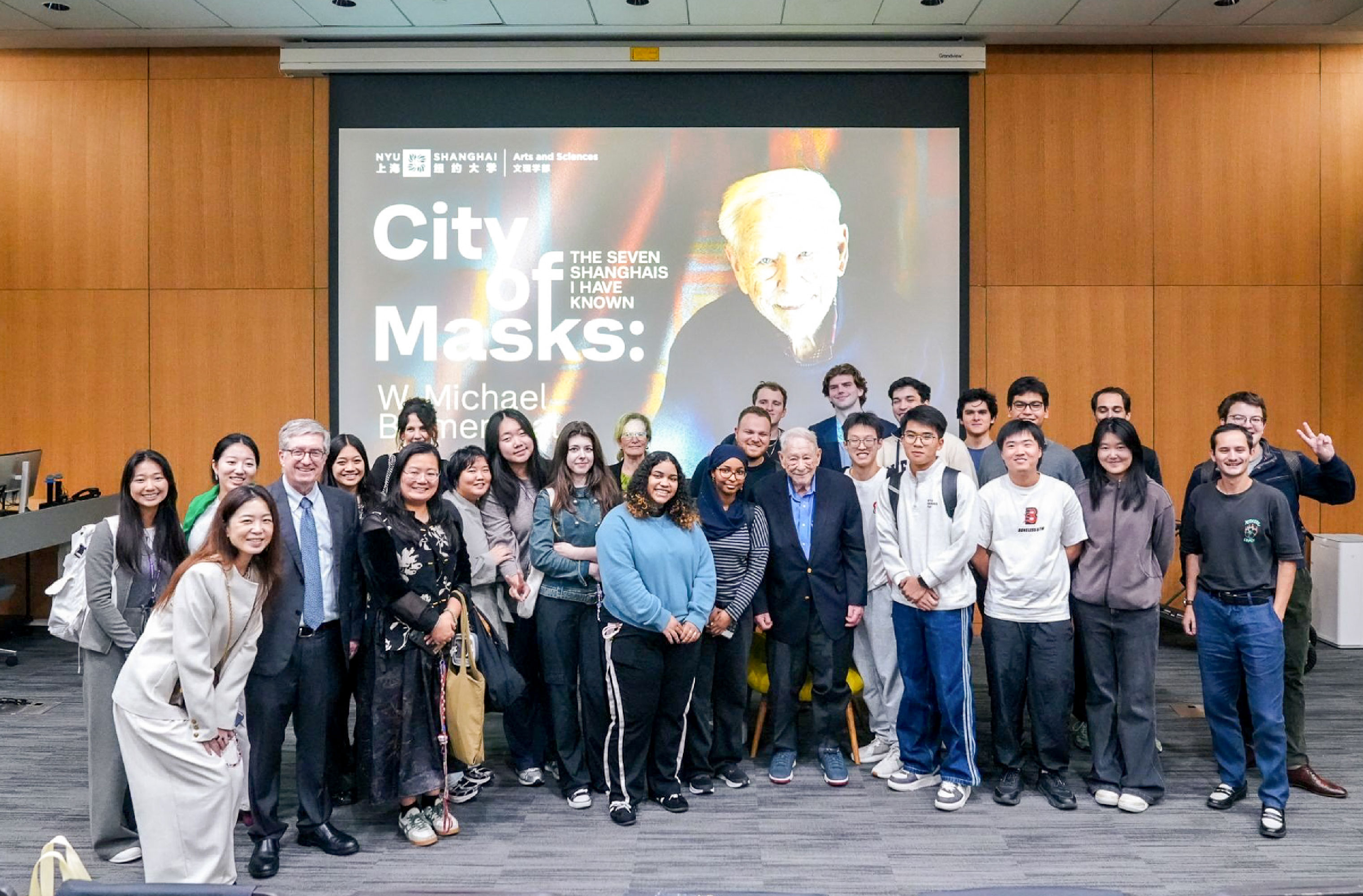 W. Michael Blumenthal (middle) posing with audience members (including Vice Chancellor Jeffrey Lehman) after the event