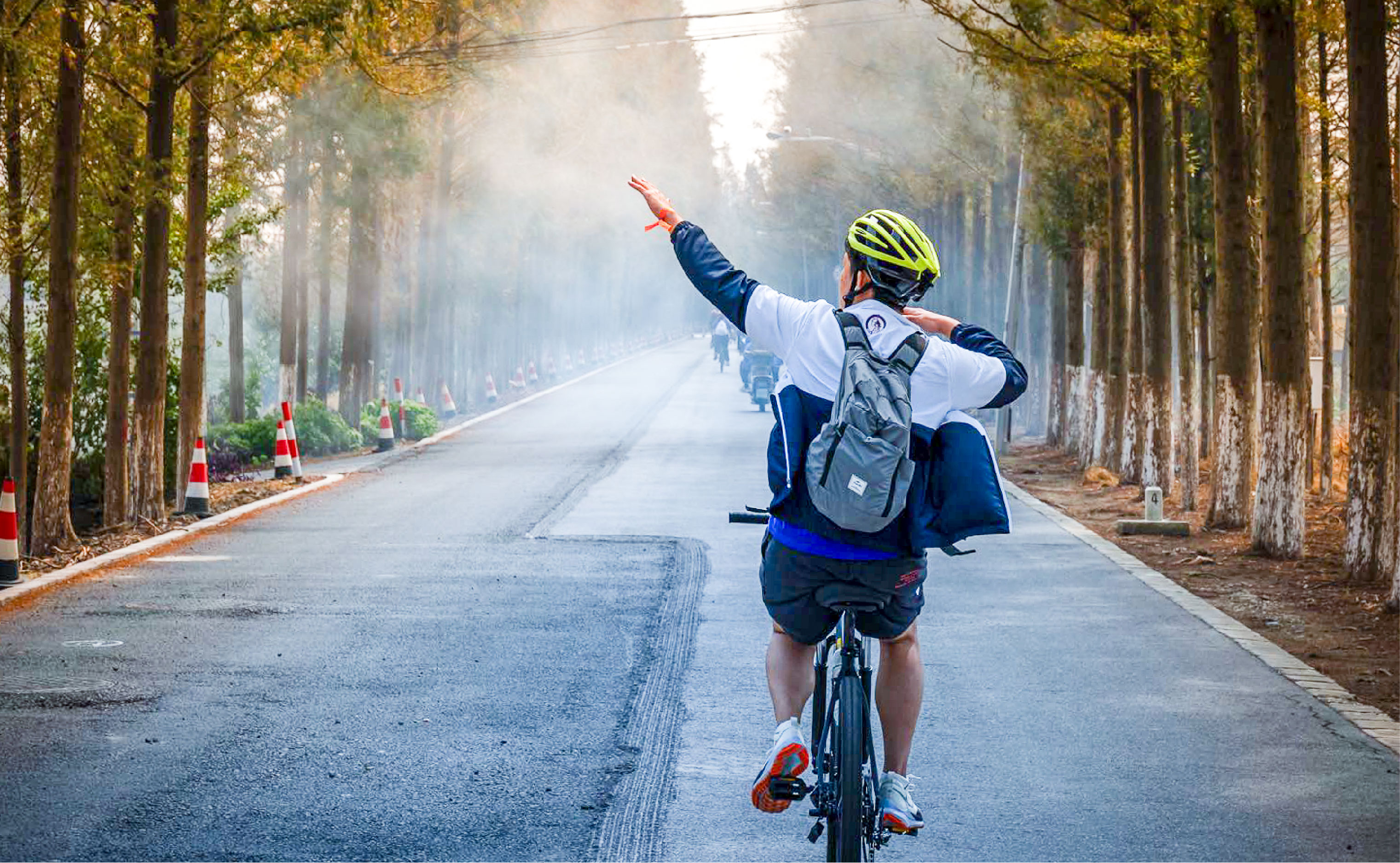 a community member poses for a photo on a bicycle