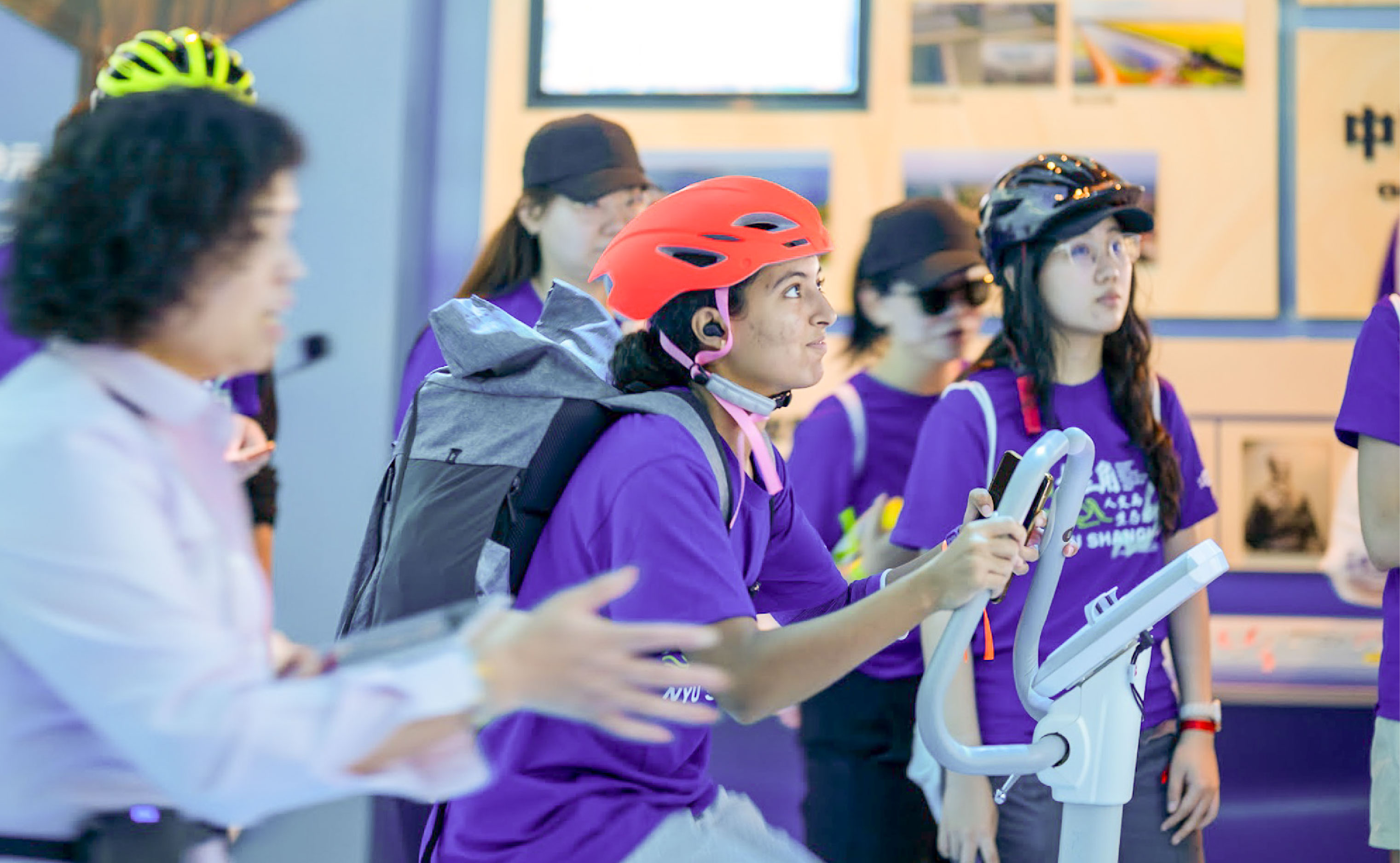 Hajar Makhchan ’28 pedaling on a stationary bike at Yangtze River Flood Control Experience Museum. 