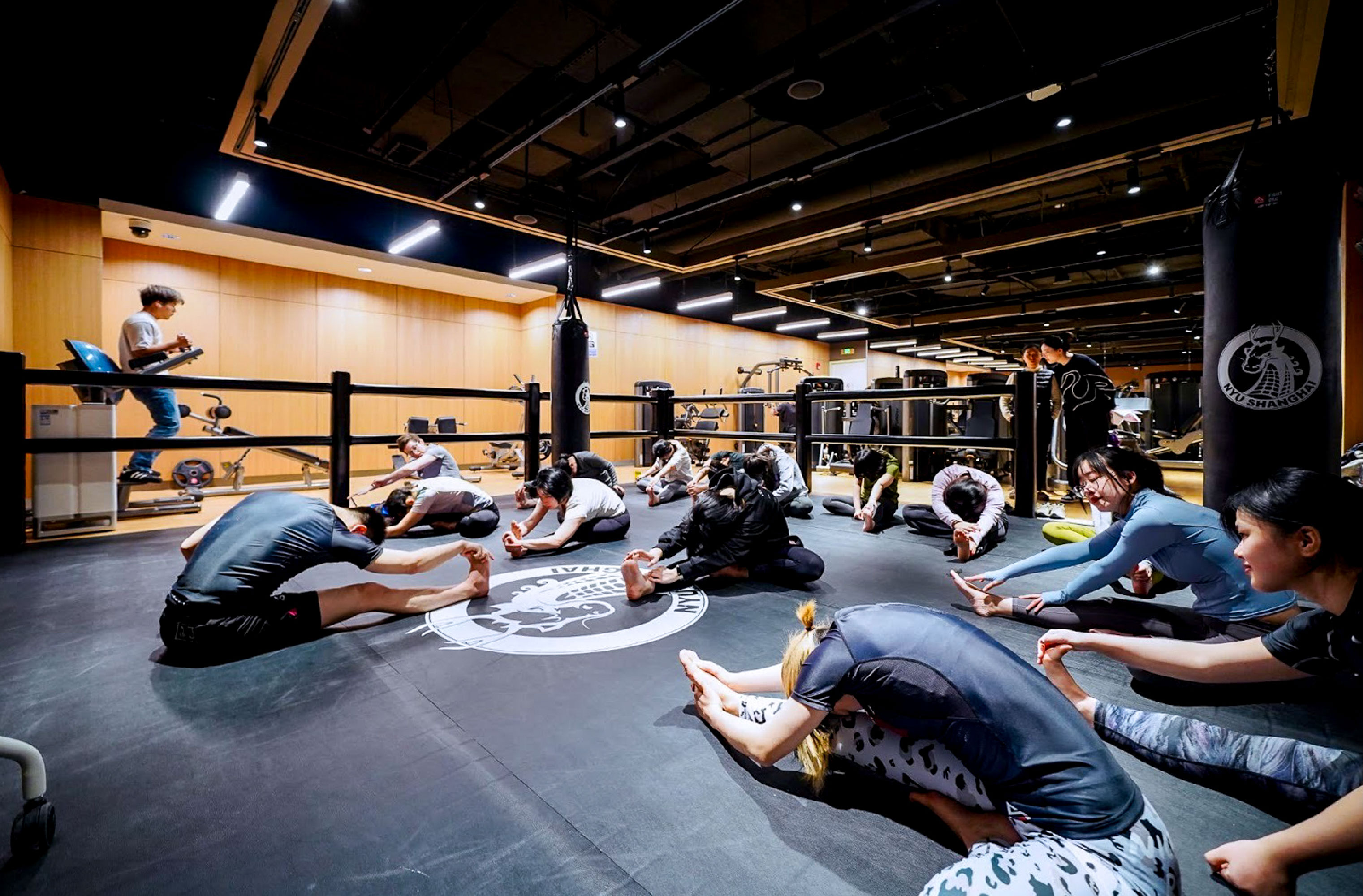 Warming up with stretches before a Brazilian jiu-jitsu course