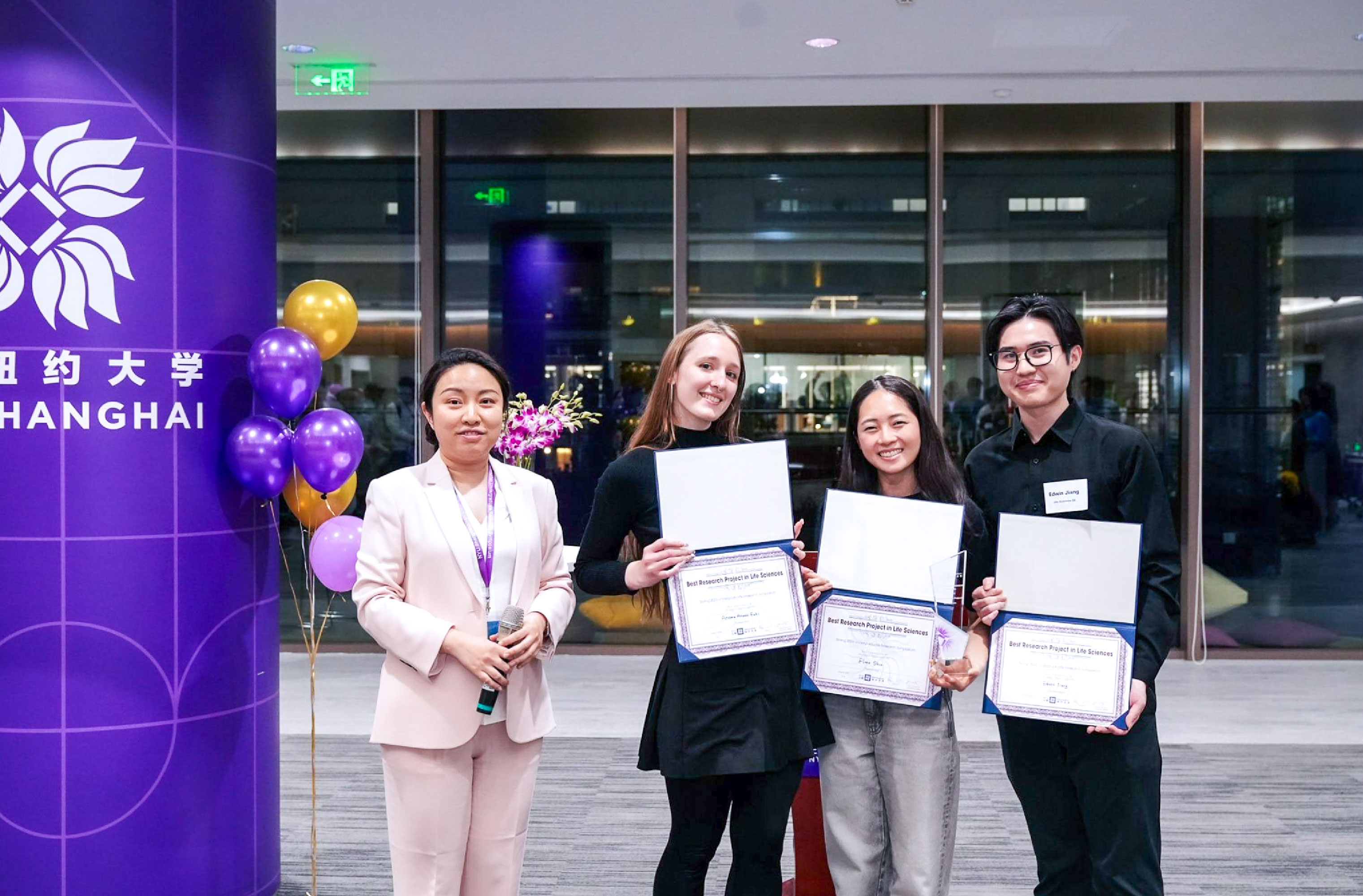 ariana fahl, edwin jiang, and flora shin accepting their award