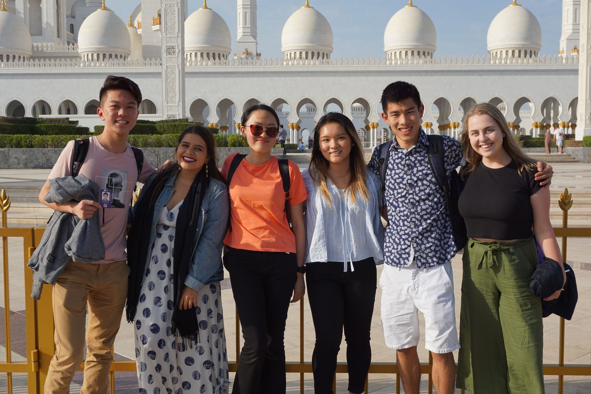 Sayama stands with the NYUSH members of the student government association in Abu Dhabi
