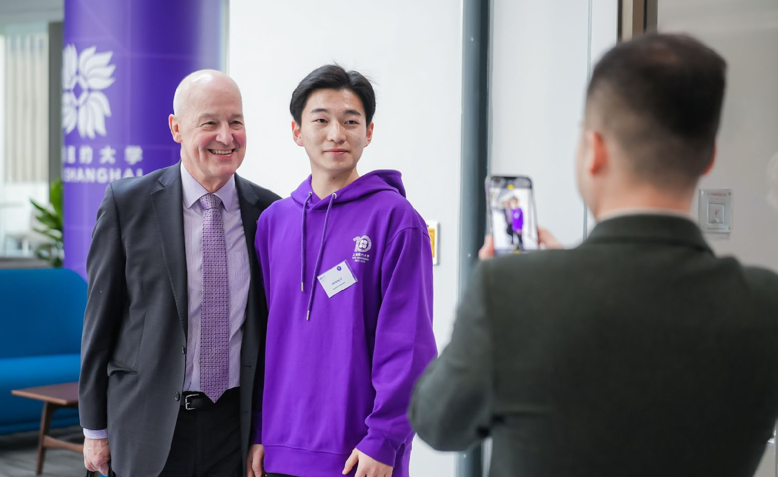 Andrew Hamilton makes an appearance and poses with a student