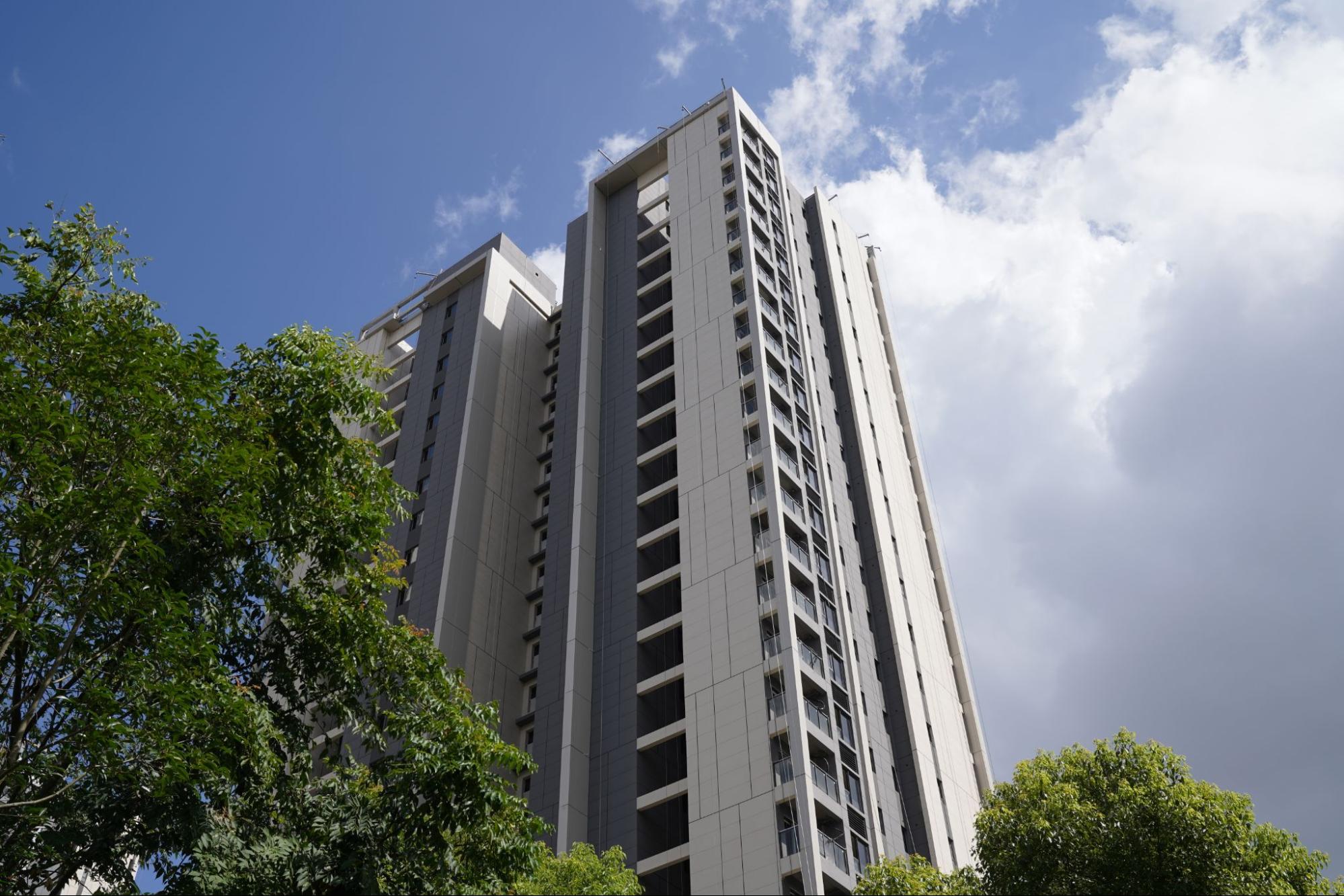 Tall building with blue sky behind. 