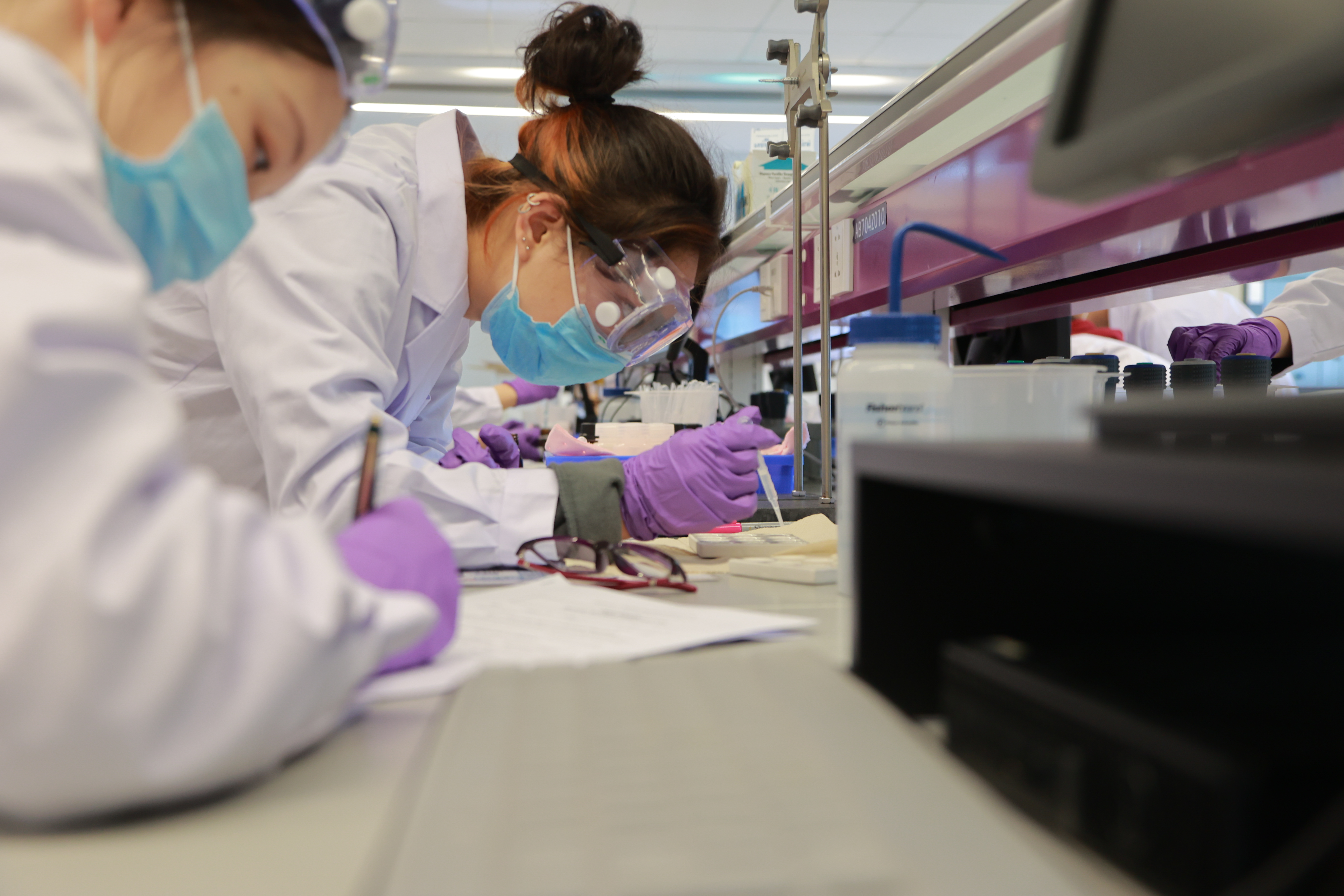 A student leans over chemistry materials