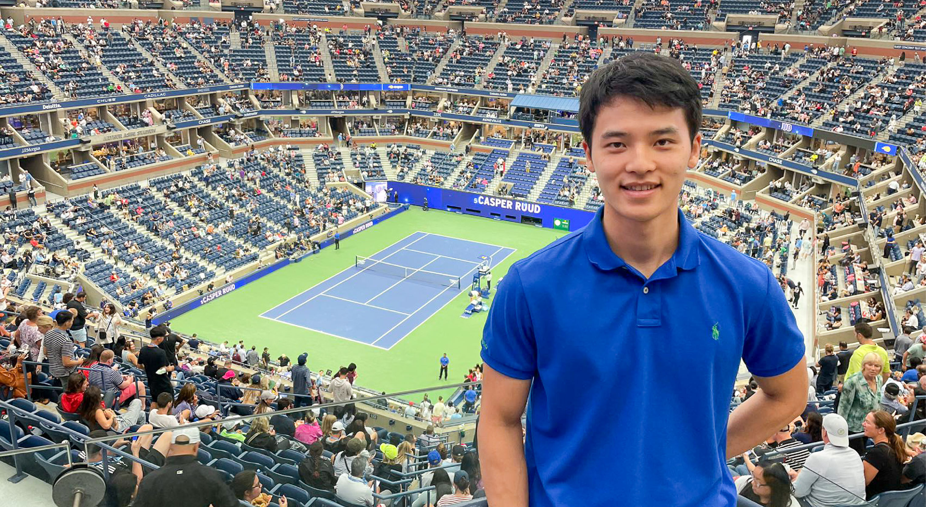 yang zhiheng standing in front of a tennis court
