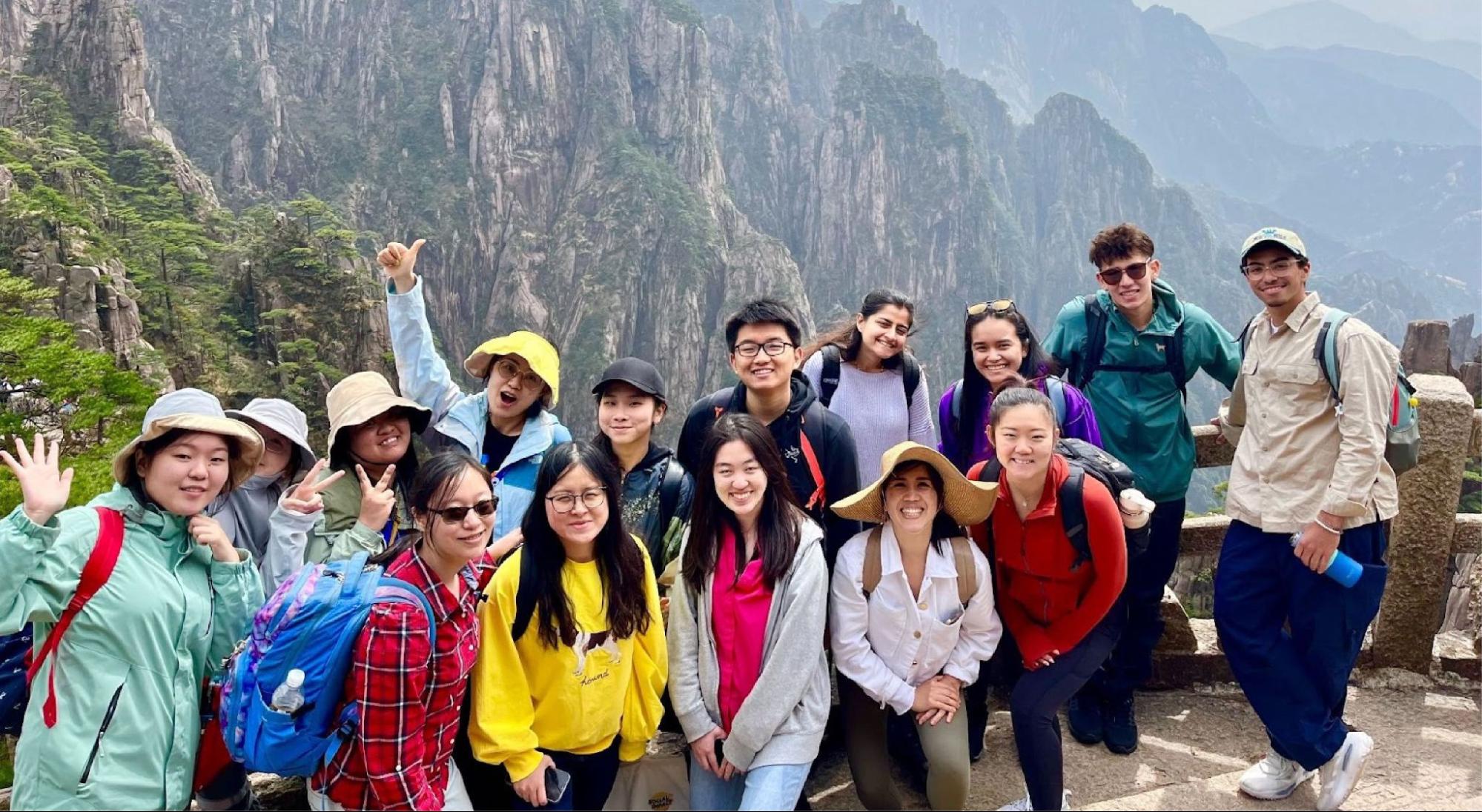 a group picture in front of the mountains