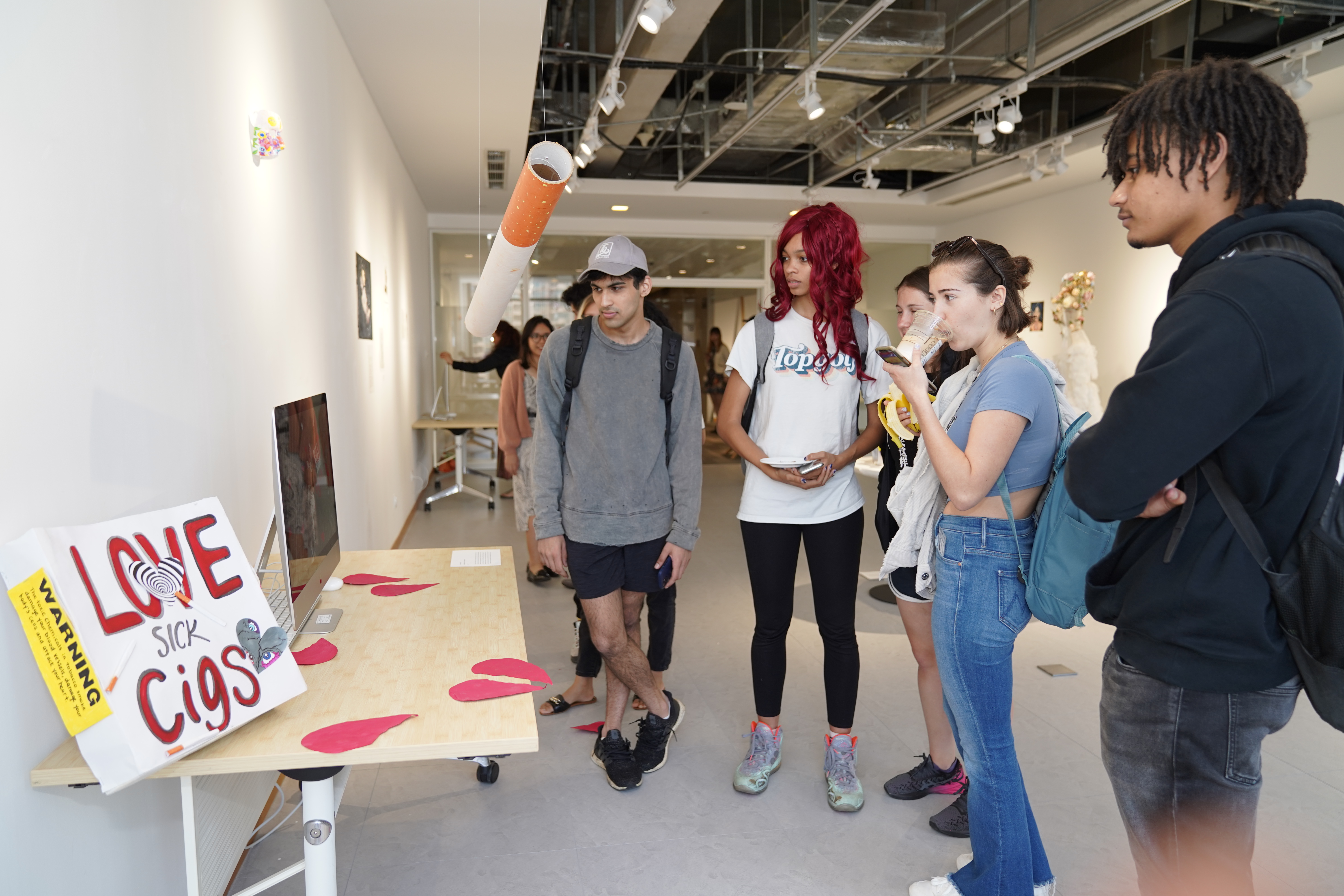 Students look at an art piece together 