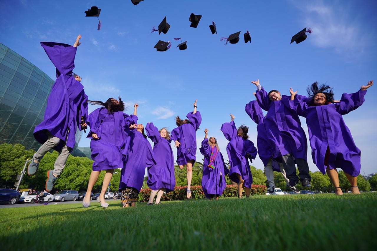 Students throw their caps into the air at graduation