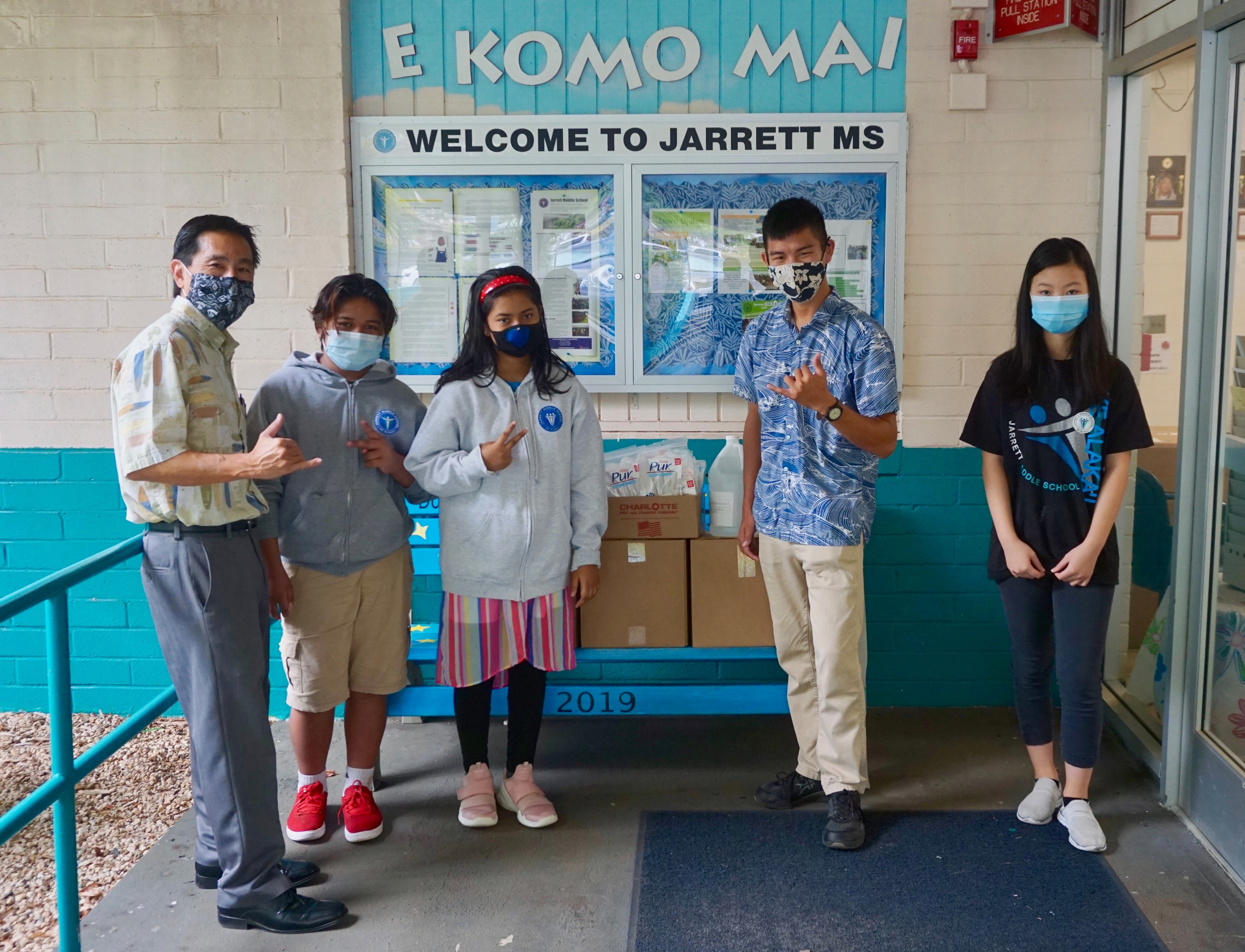 Sayama stands outside of a middle school after donating PPE