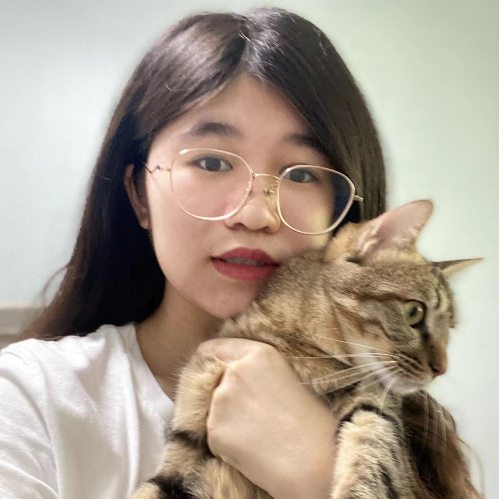 Julie Wu posing with her cat