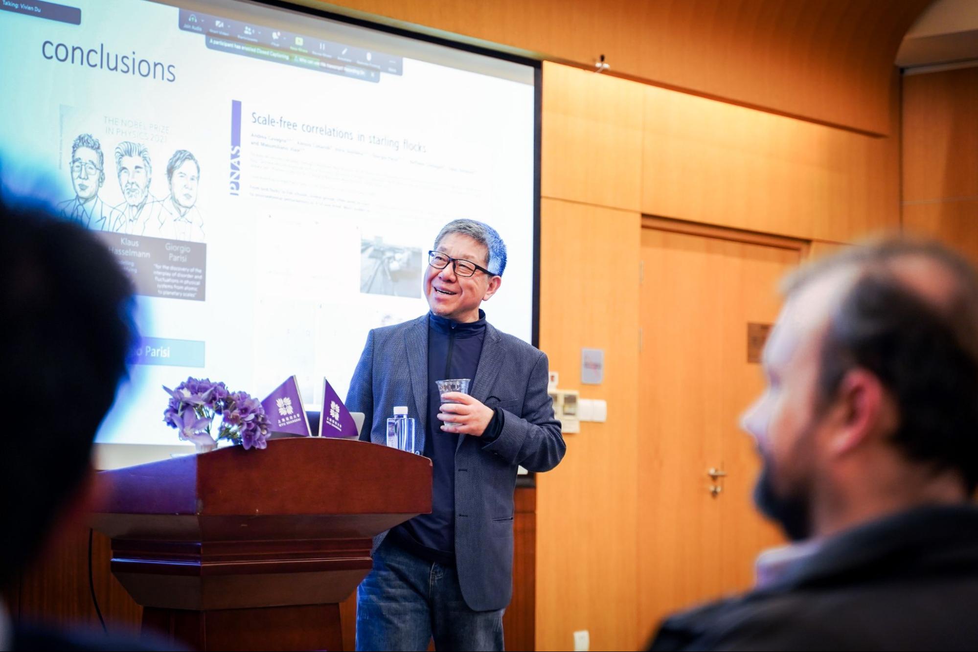 Professor Jun Zhang standing at the front of the room