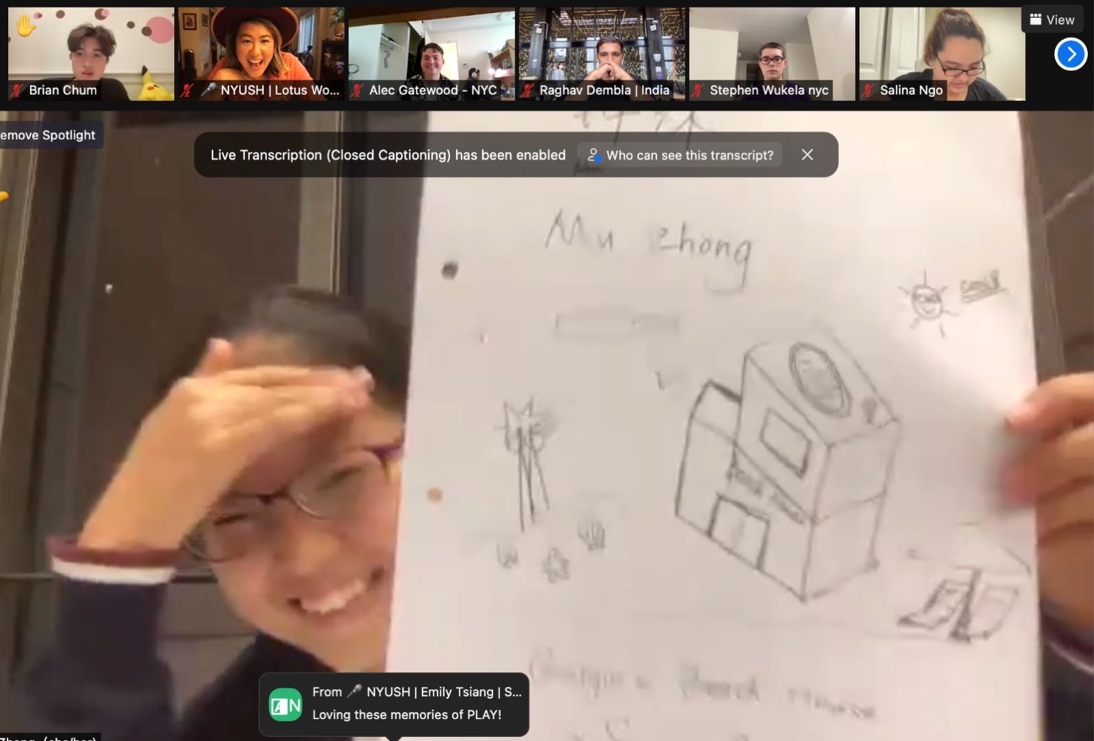 Mu holds her beach house drawing to show her classmates