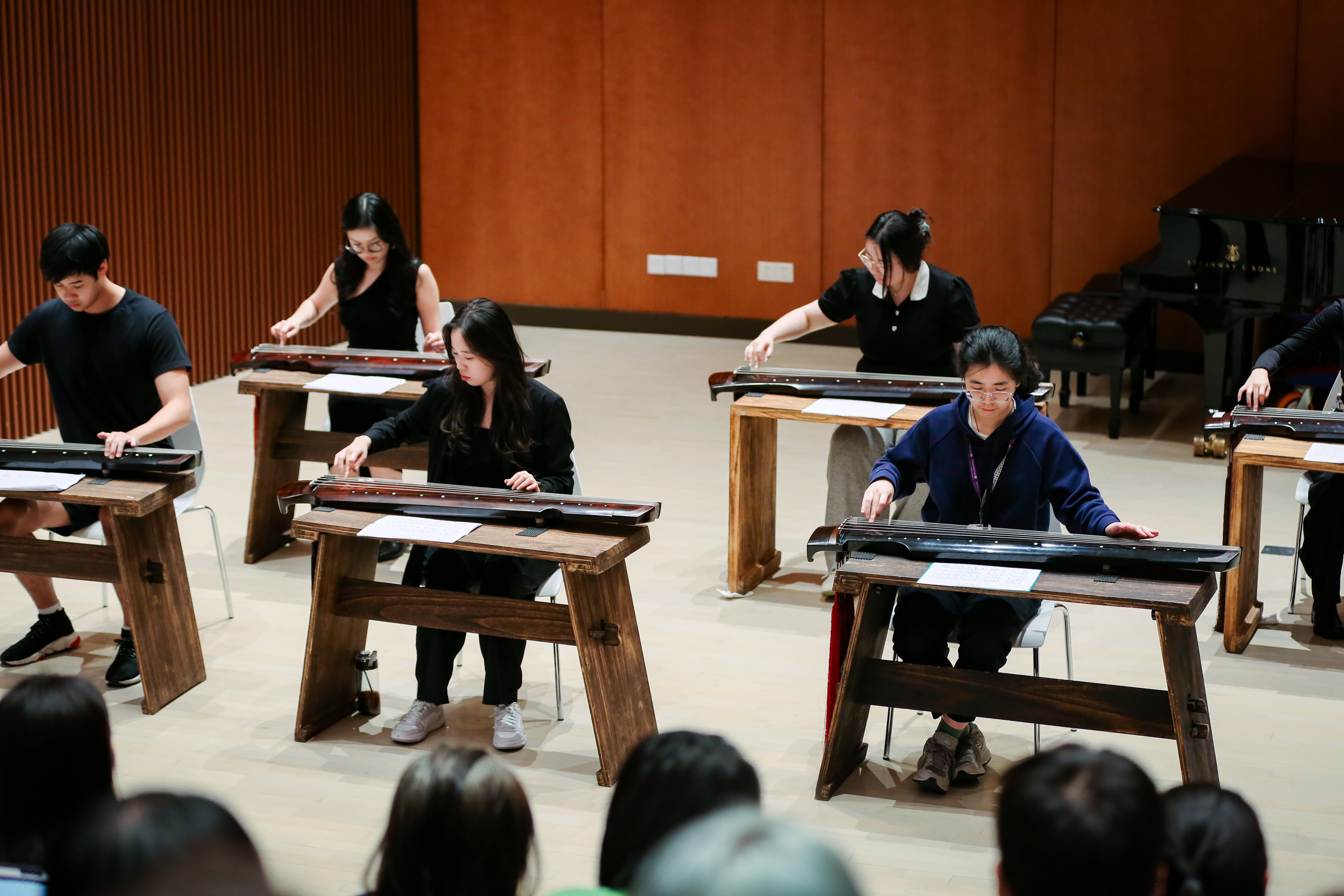 Several students play guqin together