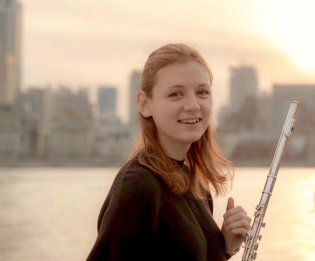 With flute on Bund at sunset