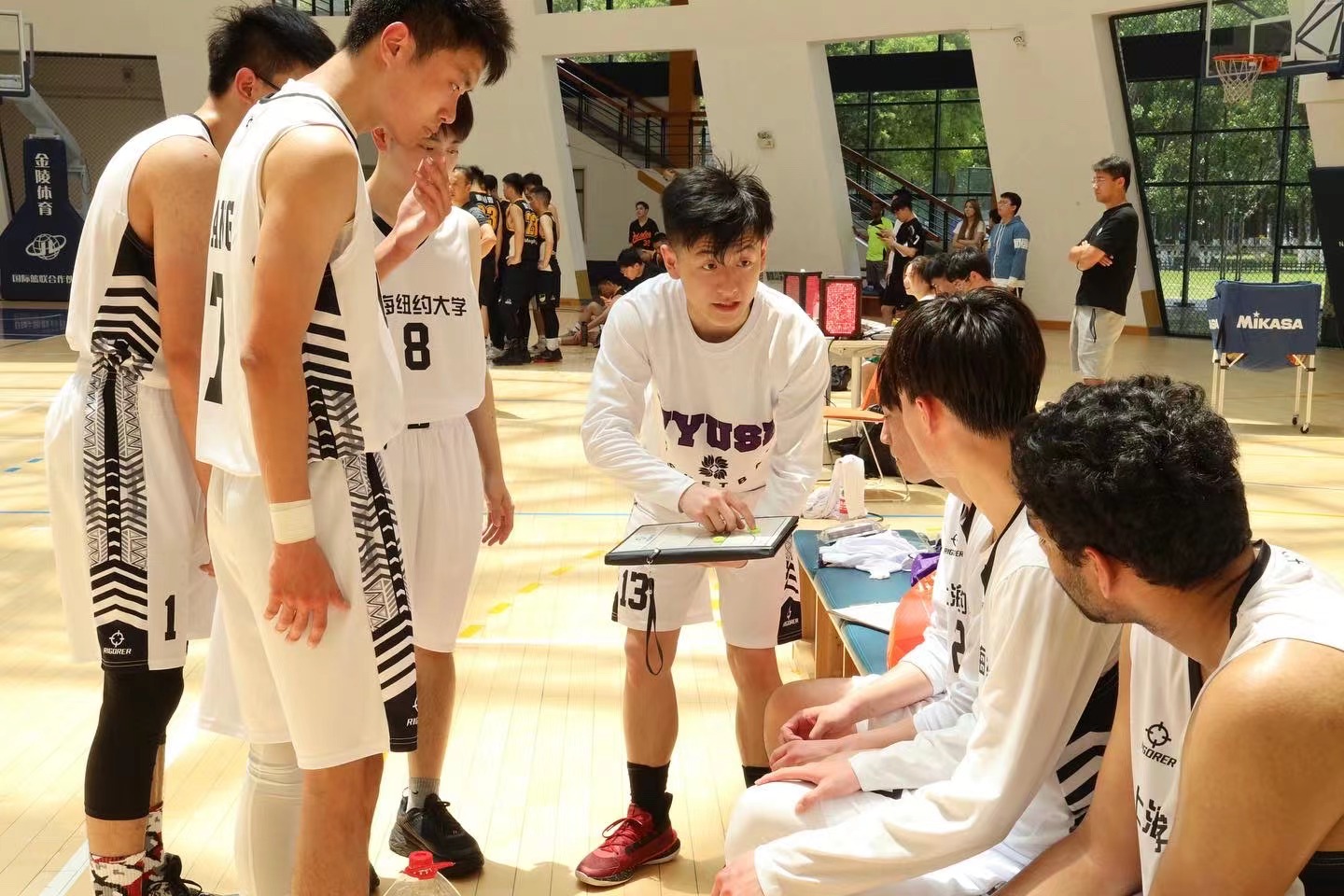 Cai coaching his teammates in a basketball game. 