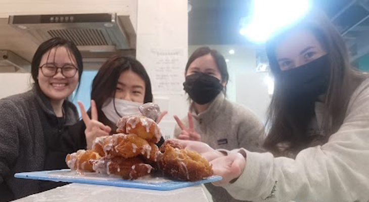 Students holding a plate of donuts