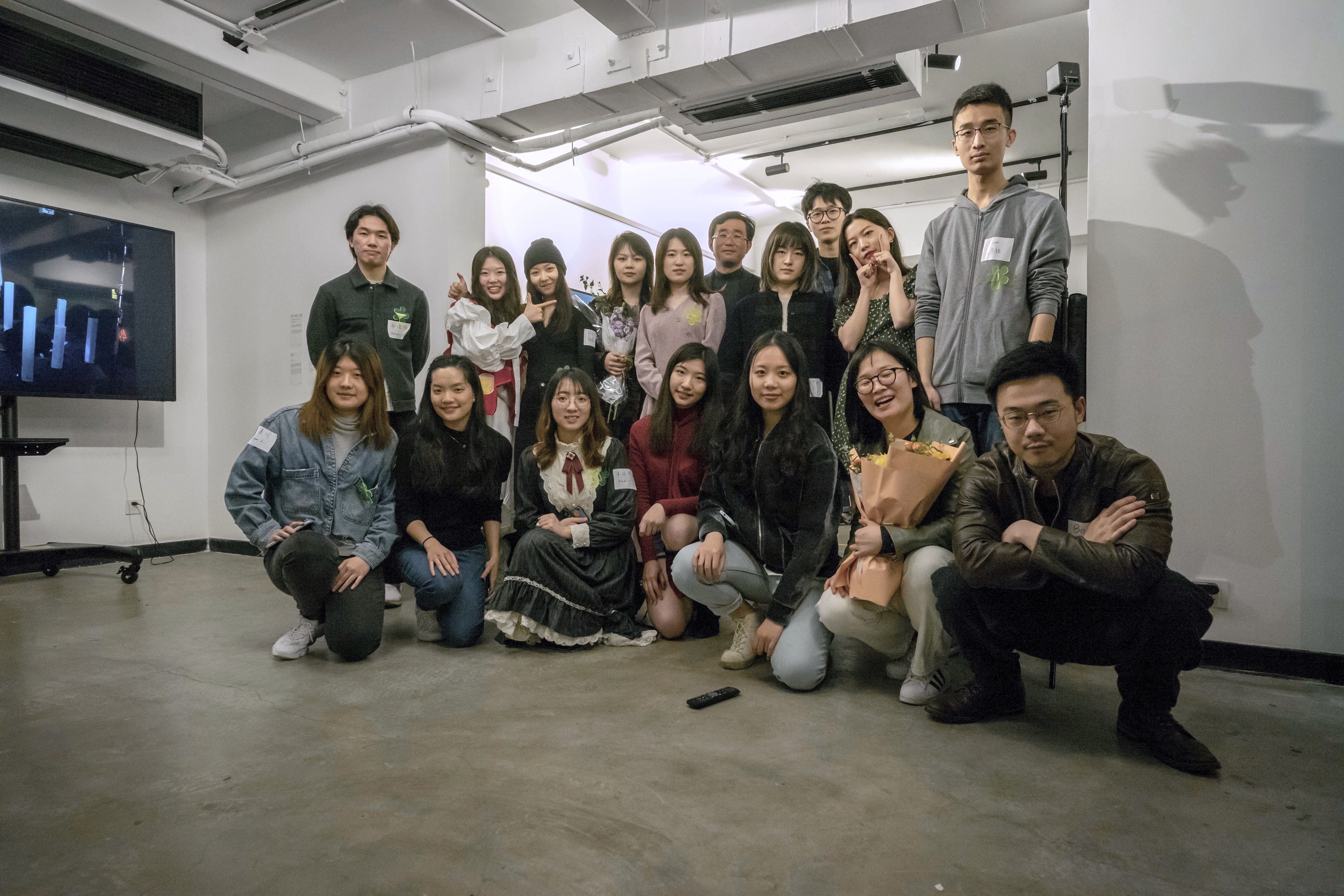 the seventeen in-person students pose at the gallery's opening