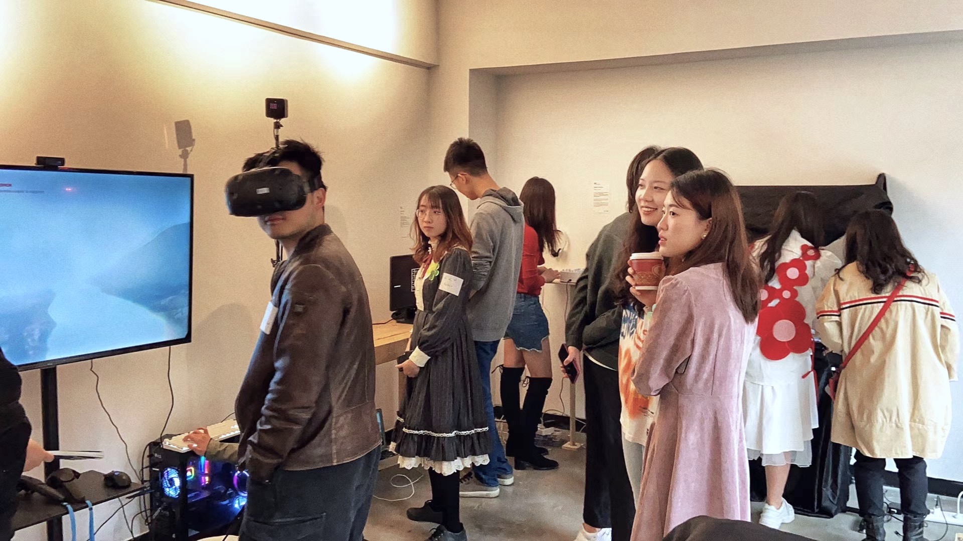 A student stands with VR goggles on, trying out the iFly installation 