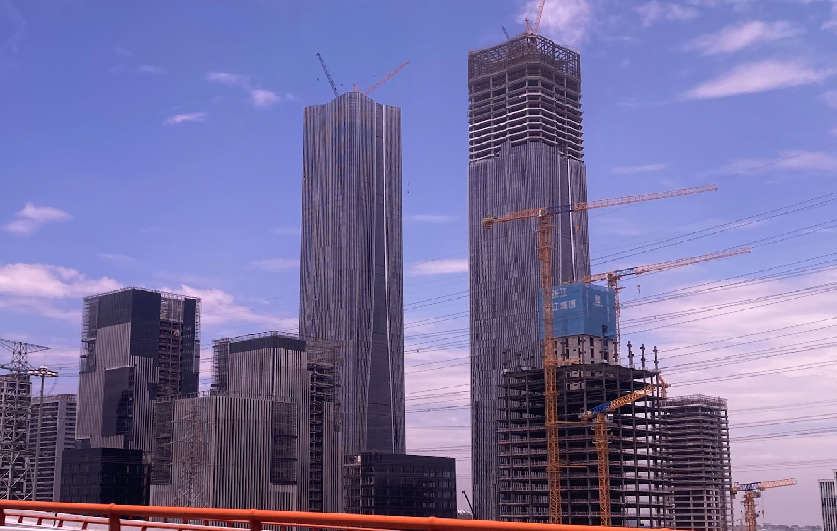 A skyscraper being built with a purple sunset behind. 