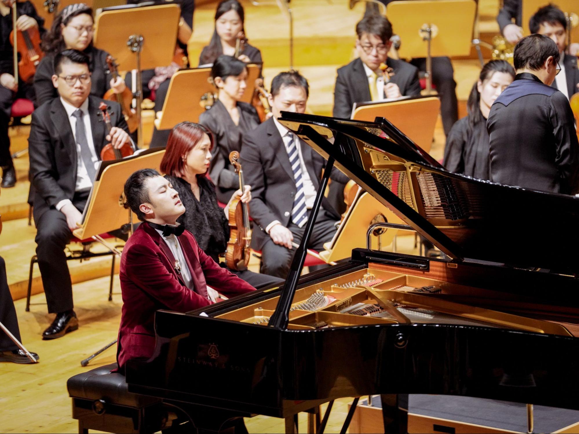 Pianist Xie Ming sits at the piano during his solo