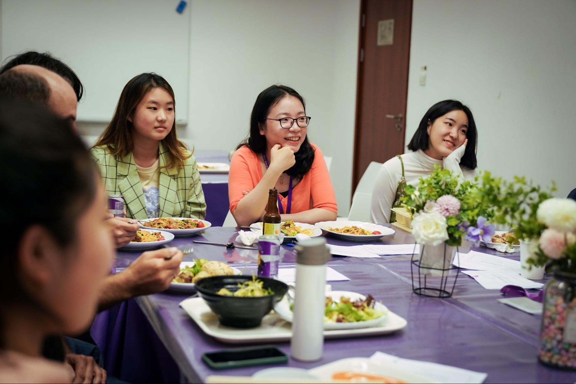 Dr. Yuan and two students engage in conversation at lunch