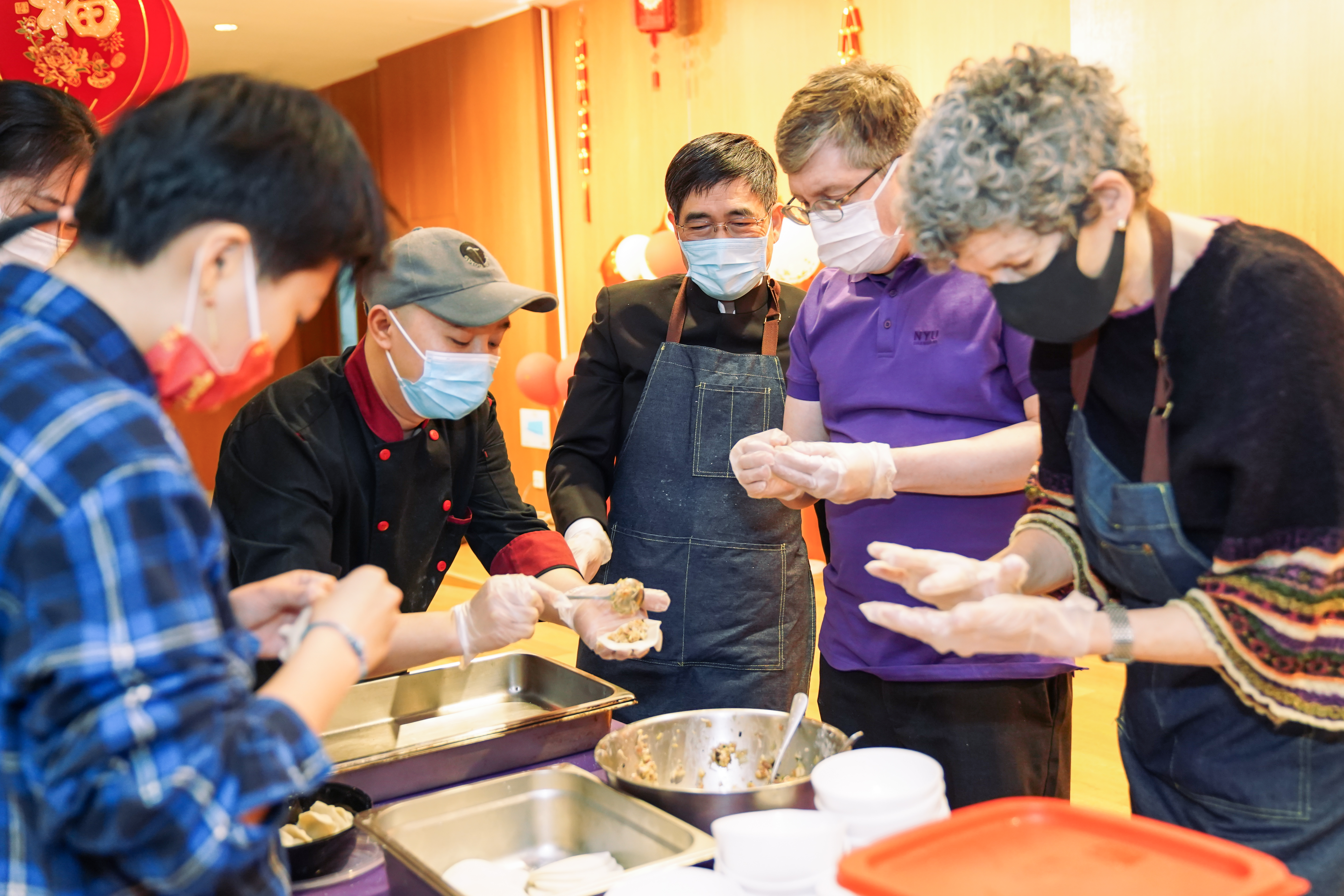 University leaders don aprons to wrap fresh dumplings for Chinese New Year