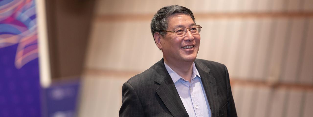 NYU Shanghai Chancellor Emeritus Yu Lizhong Smiling Chancellor Yu walks up NYU Shanghai auditorium steps.