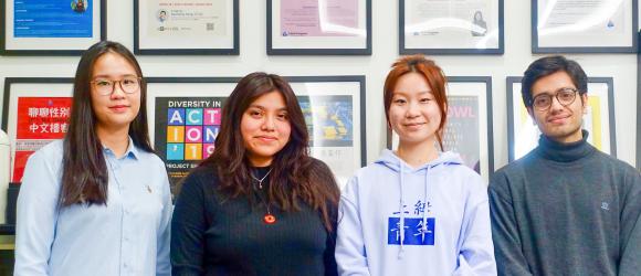 four NYU Shanghai students are pictured here posing for a group photo.