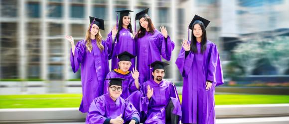 graduates in their caps and gowns on the quad