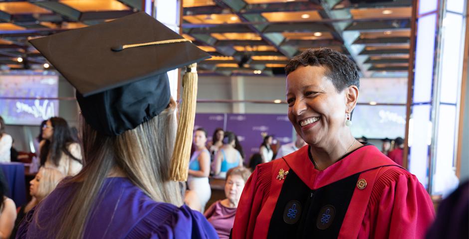 Professor Almaz Zelleke greets a graduate. ©Myaskovsky: Courtesy of NYU Photo Bureau