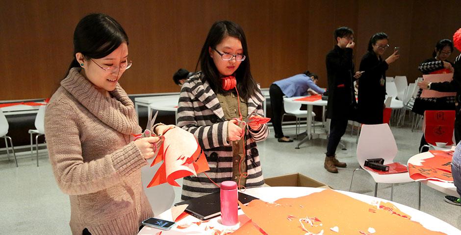 In honor of China's annual Lantern Festival, which marks the last day of Lunar New Year celebrations, students participate in paper cutting, learn Chinese calligraphy, and cook traditional tangyuan (汤圆). March 5, 2015. (Photo by Sunyi Wang)