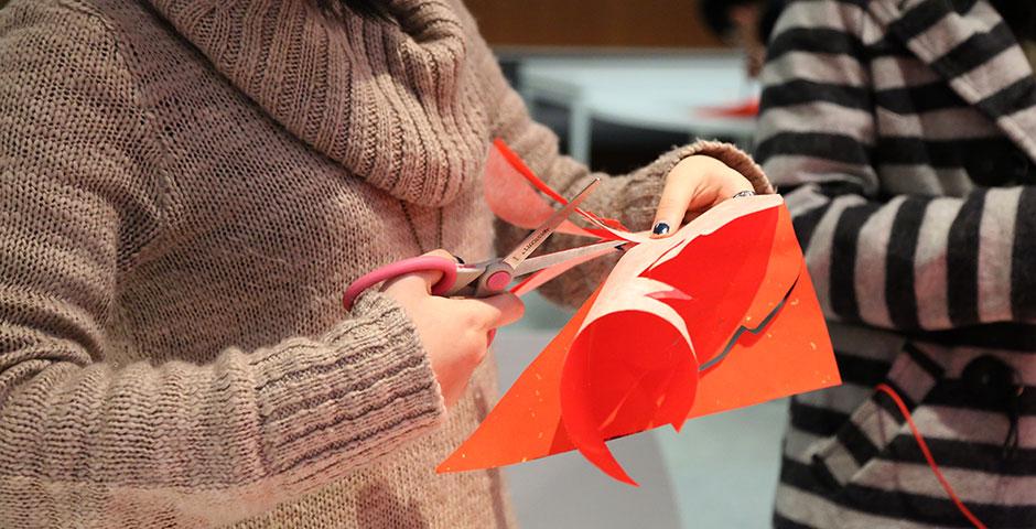 In honor of China's annual Lantern Festival, which marks the last day of Lunar New Year celebrations, students participate in paper cutting, learn Chinese calligraphy, and cook traditional tangyuan (汤圆). March 5, 2015. (Photo by Sunyi Wang)