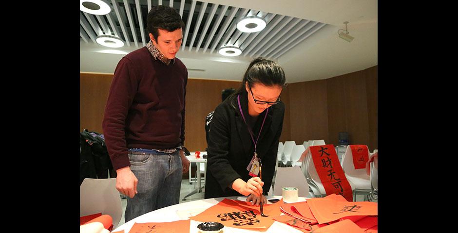 In honor of China's annual Lantern Festival, which marks the last day of Lunar New Year celebrations, students participate in paper cutting, learn Chinese calligraphy, and cook traditional tangyuan (汤圆). March 5, 2015. (Photo by Sunyi Wang)