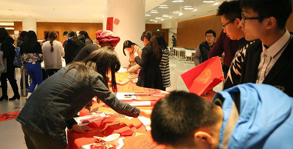 In honor of China's annual Lantern Festival, which marks the last day of Lunar New Year celebrations, students participate in paper cutting, learn Chinese calligraphy, and cook traditional tangyuan (汤圆). March 5, 2015. (Photo by Sunyi Wang)