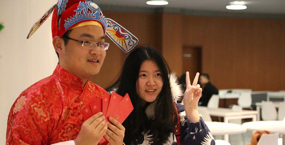 In honor of China's annual Lantern Festival, which marks the last day of Lunar New Year celebrations, students participate in paper cutting, learn Chinese calligraphy, and cook traditional tangyuan (汤圆). March 5, 2015. (Photo by Sunyi Wang)