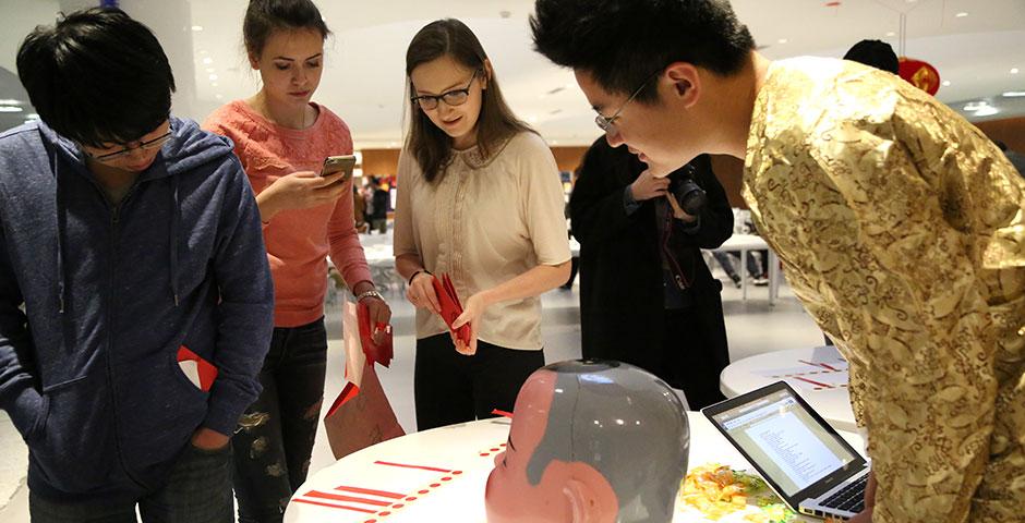 In honor of China's annual Lantern Festival, which marks the last day of Lunar New Year celebrations, students participate in paper cutting, learn Chinese calligraphy, and cook traditional tangyuan (汤圆). March 5, 2015. (Photo by Sunyi Wang)