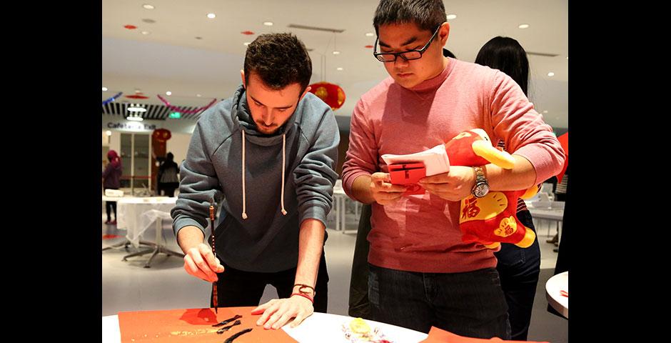 In honor of China's annual Lantern Festival, which marks the last day of Lunar New Year celebrations, students participate in paper cutting, learn Chinese calligraphy, and cook traditional tangyuan (汤圆). March 5, 2015. (Photo by Sunyi Wang)