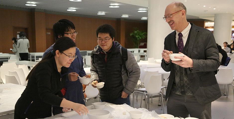 In honor of China's annual Lantern Festival, which marks the last day of Lunar New Year celebrations, students participate in paper cutting, learn Chinese calligraphy, and cook traditional tangyuan (汤圆). March 5, 2015. (Photo by Sunyi Wang)