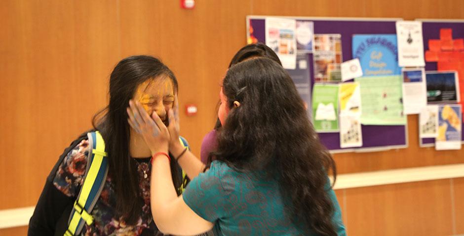 To celebrate Holi Festival, a Hindu festival with colored powder and water fights, the Food and Festivals Club dusts students' faces with colored chalk. March 6, 2015. (Photo by Annie Seaman)