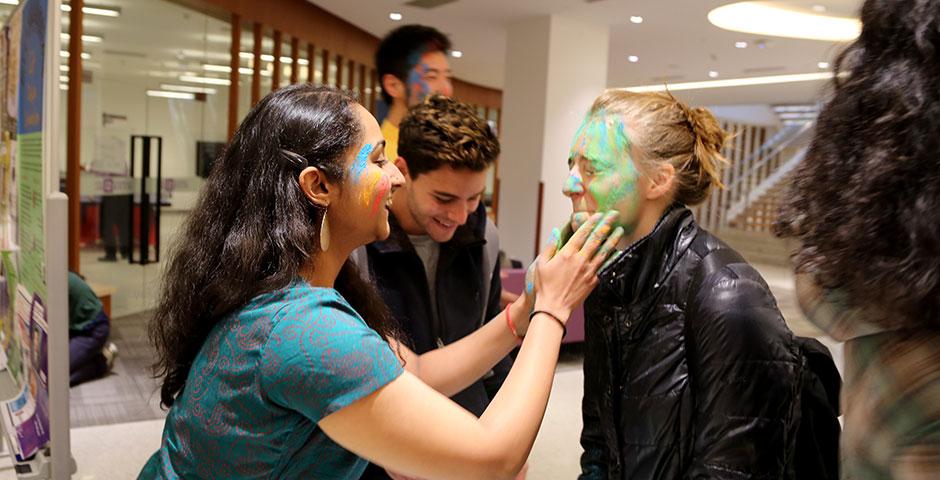 To celebrate Holi Festival, a Hindu festival with colored powder and water fights, the Food and Festivals Club dusts students' faces with colored chalk. March 6, 2015. (Photo by Annie Seaman)