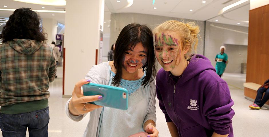 To celebrate Holi Festival, a Hindu festival with colored powder and water fights, the Food and Festivals Club dusts students' faces with colored chalk. March 6, 2015. (Photo by Annie Seaman)