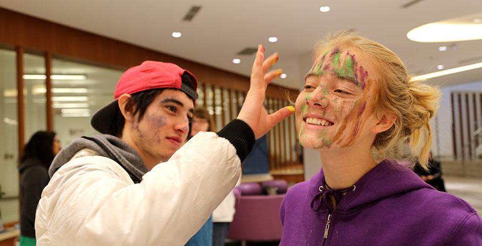 To celebrate Holi Festival, a Hindu festival with colored powder and water fights, the Food and Festivals Club dusts students&#039; faces with colored chalk. March 6, 2015. (Photo by Annie Seaman)