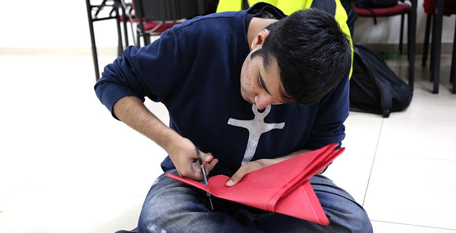 Students prepare for the upcoming Spring Festival holiday by creating traditional Chinese paper cuttings. February 1, 2015. (Photo by Annie Seaman)