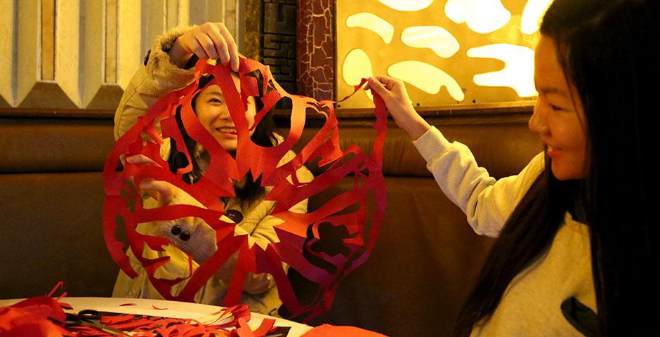 Students prepare for the upcoming Spring Festival holiday by creating traditional Chinese paper cuttings. February 1, 2015. (Photo by Annie Seaman)