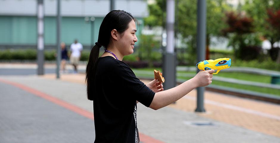 Students wrap up Stressbusters Week with an outdoor fiesta of watergun fights, pizza, and music. May 16, 2015. (Photo by Kevin Pham)
