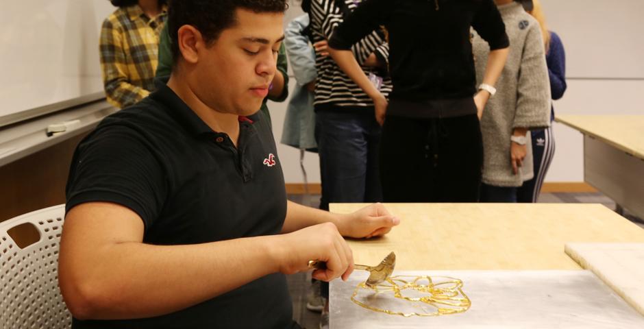 NYU Shanghai students learned the Chinese folk art of sugar painting, a craft which uses melted sugar to create traditional animal and plant figures. Two Shanghainese sugar artists instructed students at the October 26 event. (Photo by: Wenqian Hu)