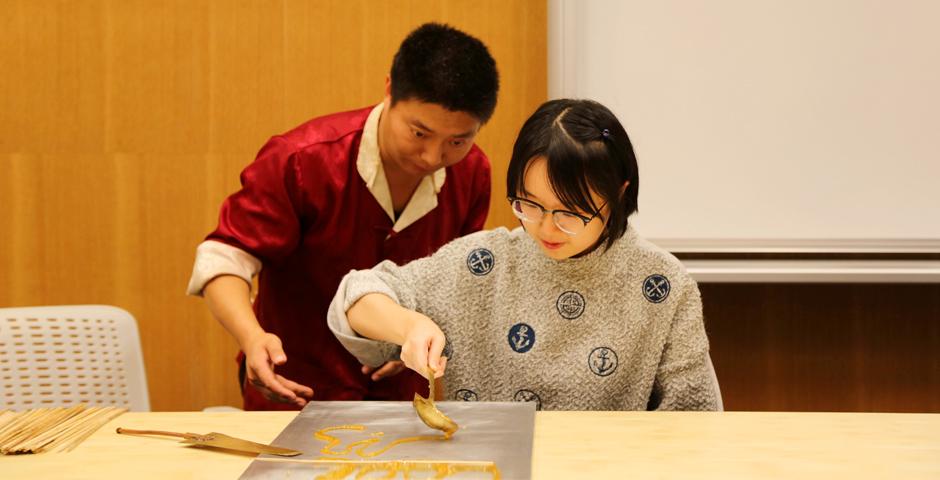 NYU Shanghai students learned the Chinese folk art of sugar painting, a craft which uses melted sugar to create traditional animal and plant figures. Two Shanghainese sugar artists instructed students at the October 26 event. (Photo by: Wenqian Hu)