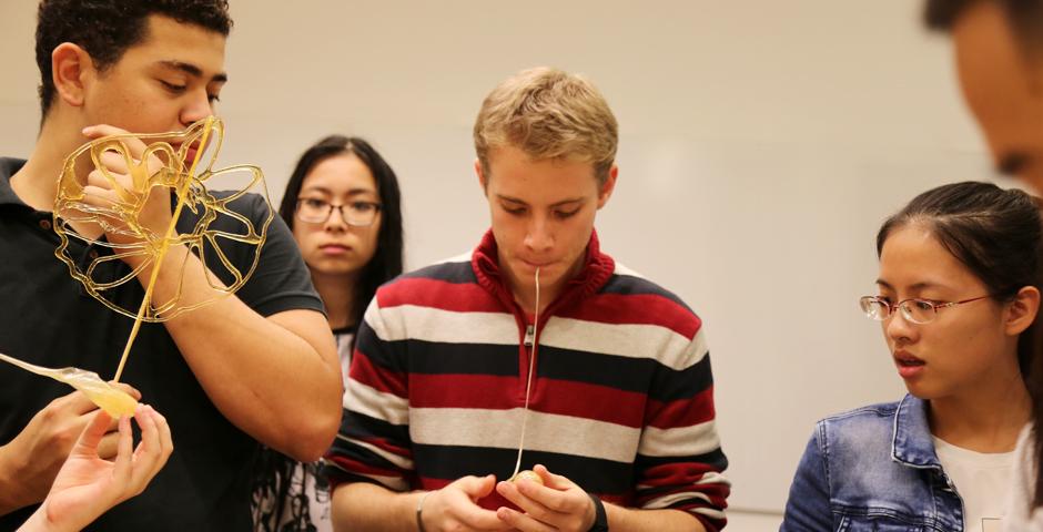 NYU Shanghai students learned the Chinese folk art of sugar painting, a craft which uses melted sugar to create traditional animal and plant figures. Two Shanghainese sugar artists instructed students at the October 26 event. (Photo by: Wenqian Hu)