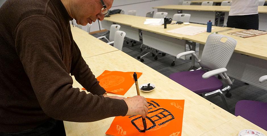 Students prepare for the Year of the Sheep with Chinese New Year writings. February 13, 2015. (Photo by Mei Wu)